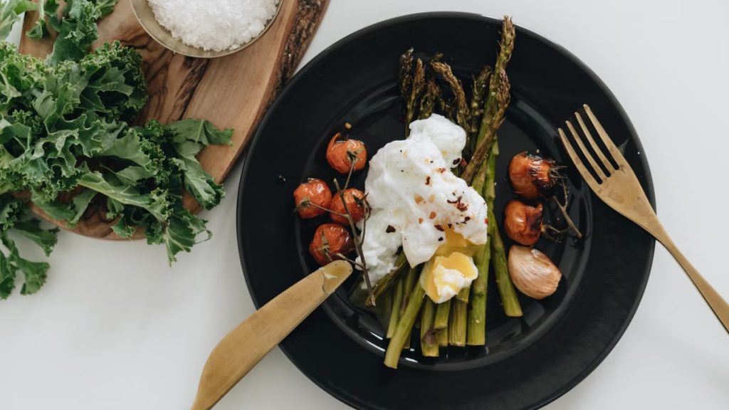 Delicious poached egg on asparagus with cherry tomatoes. Perfect for a healthy breakfast or brunch.